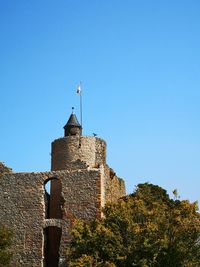 Low angle view of castle against clear blue sky