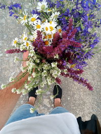 Low section of man standing on flower