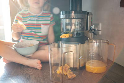 Midsection of woman holding food on table