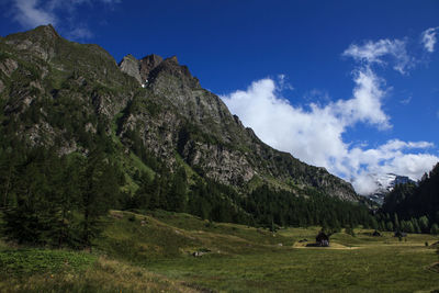 Scenic view of mountains against cloudy sky