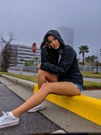 Portrait of woman sitting on road