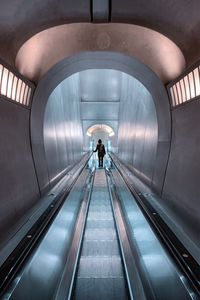 Rear view of man on escalator