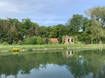 Reflection of trees in lake against sky