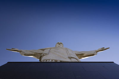 Low angle view of statue against blue sky