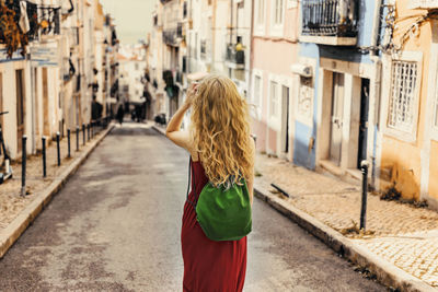 Rear view of woman standing in city
