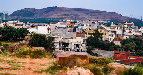High angle view of townscape and mountains against clear sky