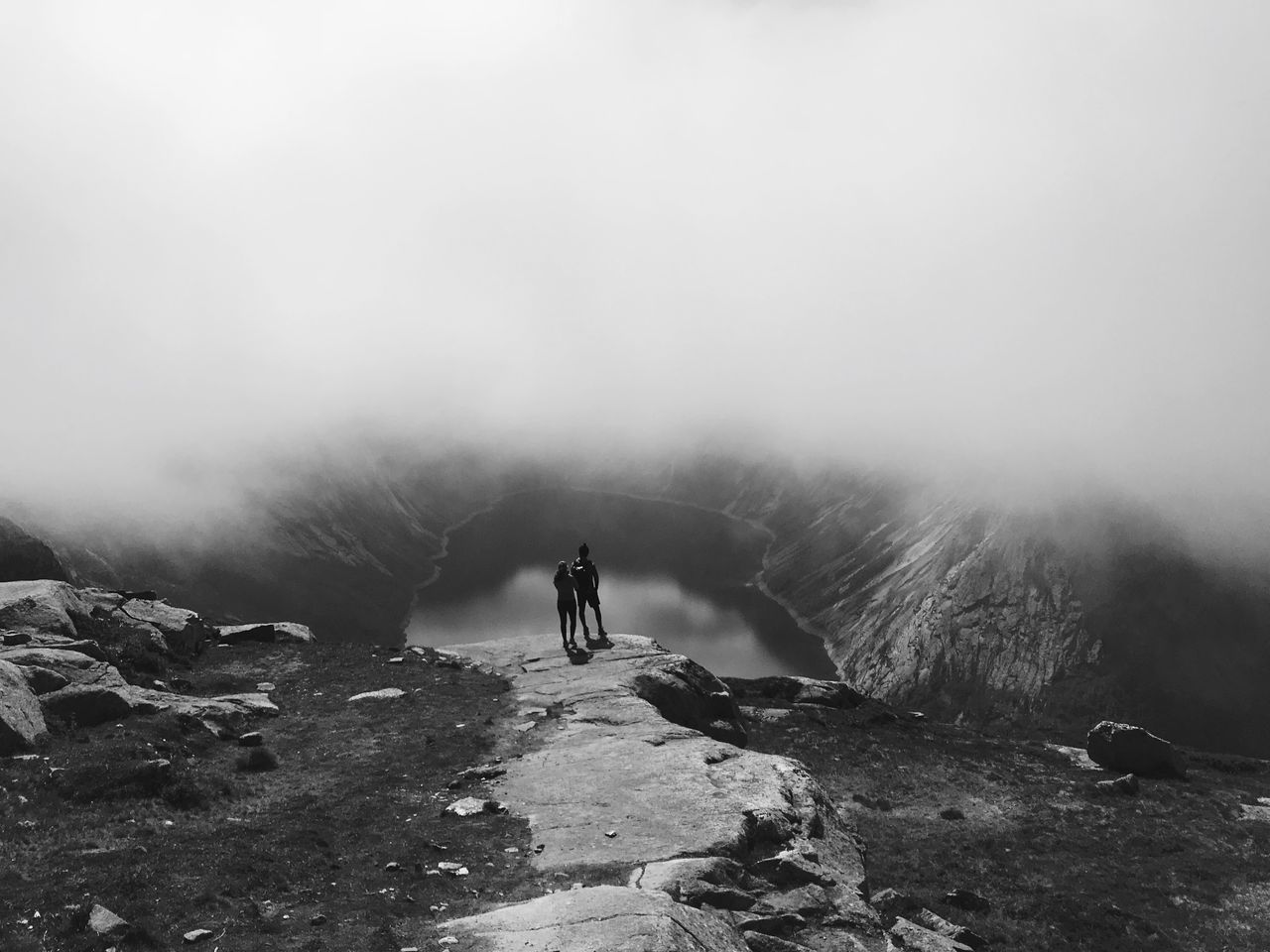 fog, beauty in nature, one person, leisure activity, real people, rock, nature, scenics - nature, day, lifestyles, non-urban scene, solid, tranquil scene, full length, rock - object, tranquility, standing, sky, outdoors