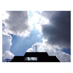 Low angle view of building against cloudy sky
