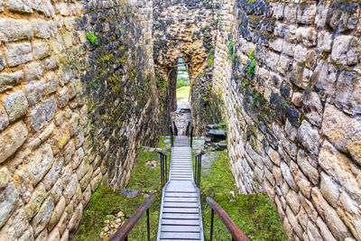 High angle view of stairs amidst stone walls