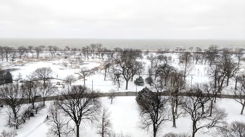 Scenic view of lake against sky during winter