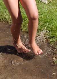 Low section of person on wet shore