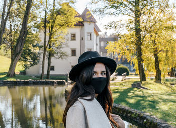 Portrait of young woman wearing black mask. covid, new normal, tourism, travel, social distancing.