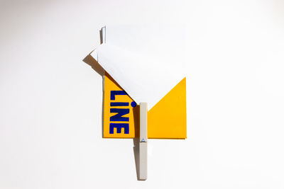 Close-up of road sign against white background