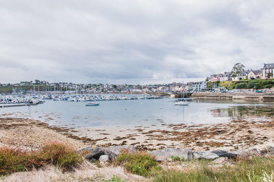 Scenic view of beach against sky in city