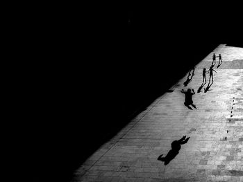 High angle view of silhouette people skating on street