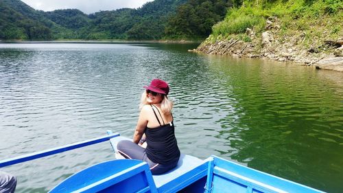 Woman sitting on boat in lake