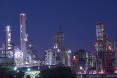 Illuminated buildings against sky at night