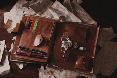 High angle view of bag and papers on table