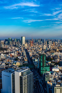 High angle view of modern buildings in city against sky