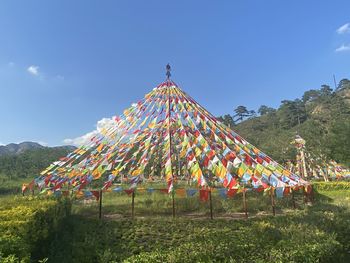 Traditional windmill on field against sky