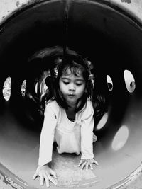Cute girl playing tunnel slide