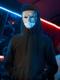 Portrait of man wearing illuminated mask