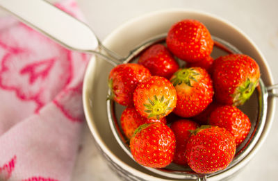 High angle view of strawberries in bowl on table