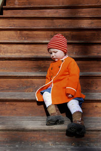 Cute girl sitting on wooden steps