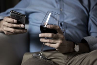 Midsection of man having rink while sitting at home