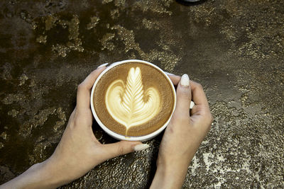 Midsection of woman holding coffee cup