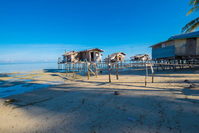 Lifeguard hut on beach against clear blue sky