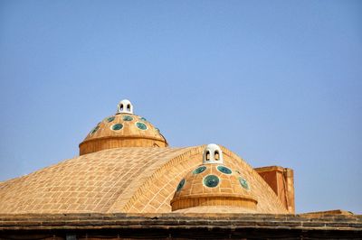 Low angle view of traditional building against clear blue sky