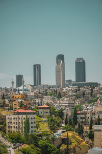 Buildings in city against clear sky