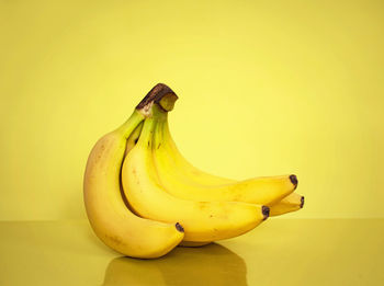 Close-up of bananas against yellow background