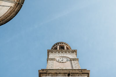 Low angle view of clock tower against sky