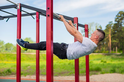 Low angle view of man photographing at playground