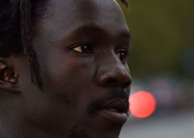 Close-up portrait of young man looking away