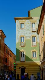 Buildings in city against blue sky