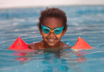 Portrait of smiling boy in swimming pool