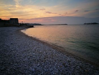 Scenic view of beach against sky during sunset