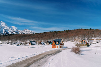 People skiing on snow covered landscape