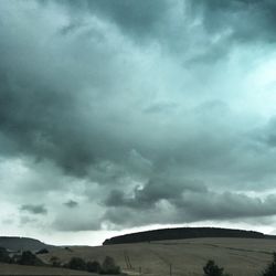 Scenic view of mountains against cloudy sky