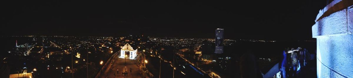 Illuminated cityscape against sky at night