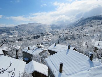 Scenic view of snow covered mountains against sky