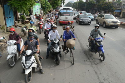 People riding motorcycle on city street