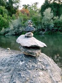 Sculpture on rock by lake