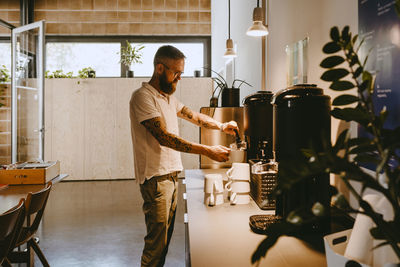 Male entrepreneur having coffee break in office