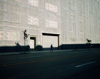 Man walking on road in city