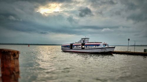 Boat moored on sea against sky