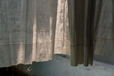 Close-up of curtain against window at home